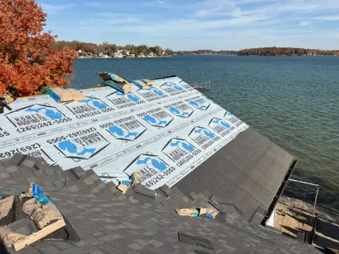 Underlayment going on during a lakeside roof replacement