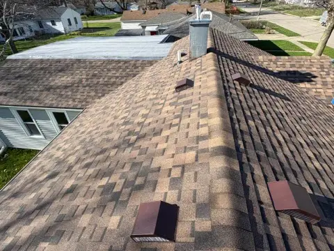 Finished ridge and vents on a new shingle roof