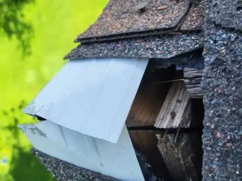 Damaged roof edge and trim before repair