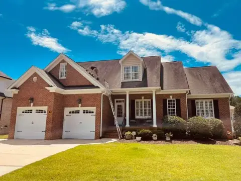 Brick home with a newly replaced shingle roof