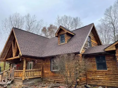 Fascia and soffit project by Homes Roofing Co on a log home